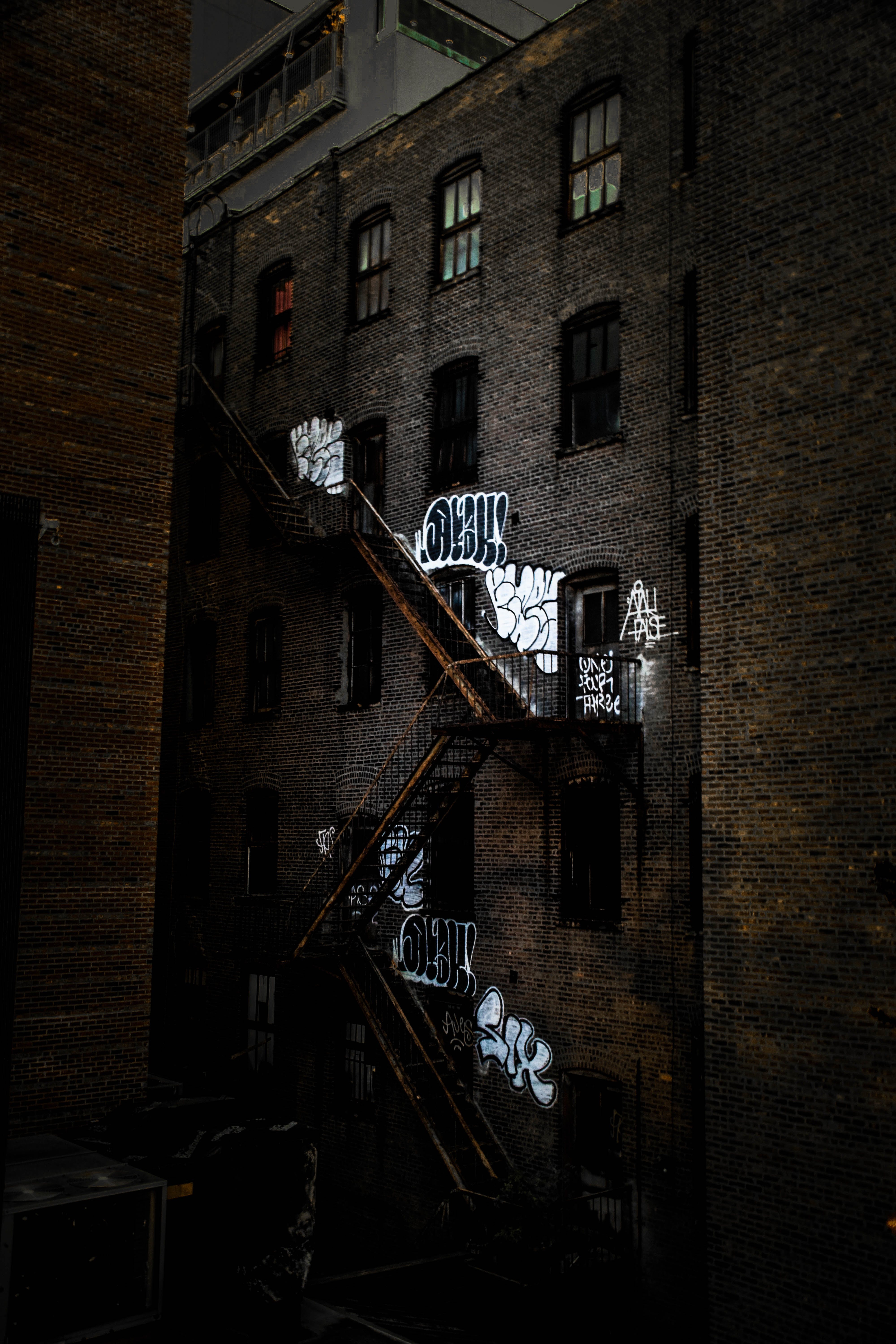 graffiti and stairs along brown brick building